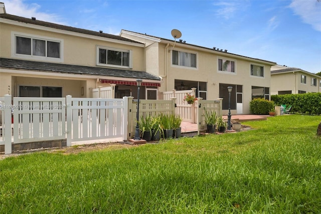 back of property featuring a lawn