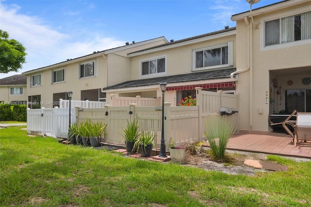 rear view of property with a yard