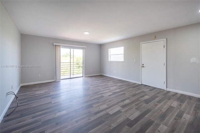 unfurnished room featuring dark wood-type flooring