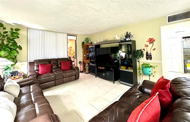 living room featuring light tile patterned floors and a textured ceiling