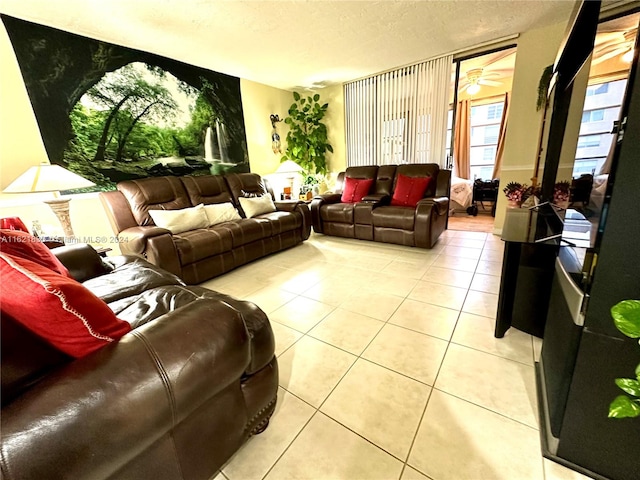 tiled living room with ceiling fan and a textured ceiling