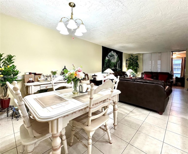 2831 Somerset Dr Unit 206, Lauderdale Lakes, FL 33311 - dining room with an inviting chandelier, a textured ceiling, and light tile patterned floors