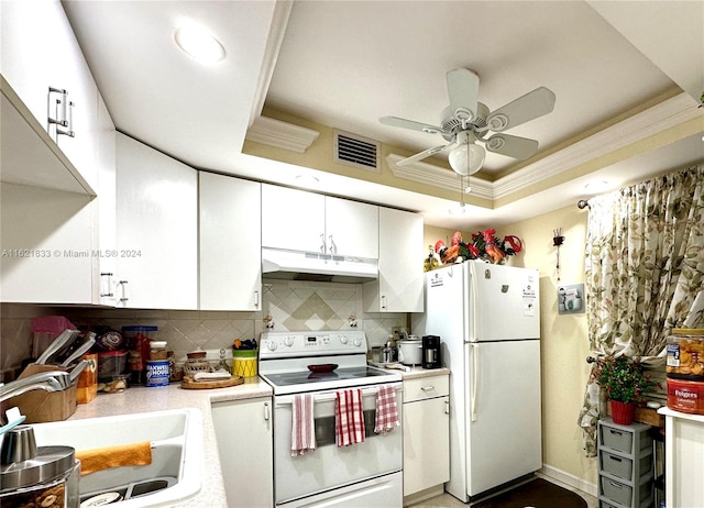 kitchen with ceiling fan, white cabinets, white appliances, a raised ceiling, and backsplash