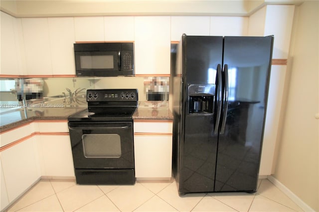 kitchen with light tile patterned floors, white cabinetry, dark stone counters, and black appliances