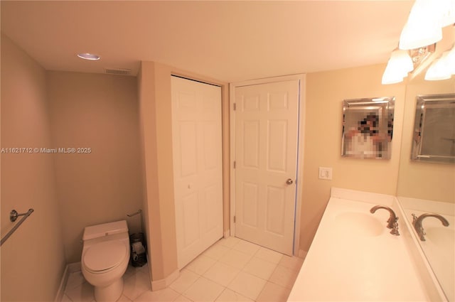 bathroom featuring tile patterned floors, vanity, and toilet