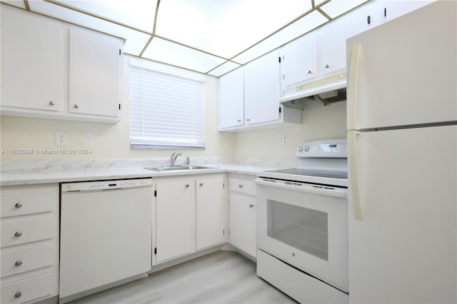 kitchen featuring sink, white cabinets, and white appliances