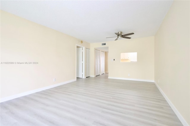 unfurnished room with ceiling fan, a textured ceiling, and light hardwood / wood-style floors