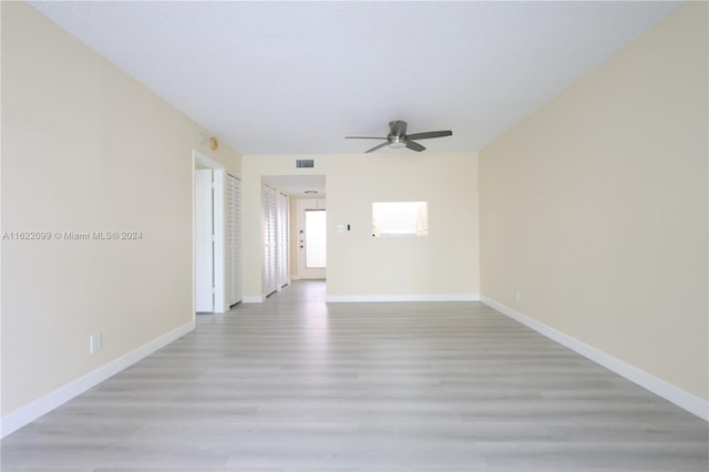 empty room featuring ceiling fan and light hardwood / wood-style flooring