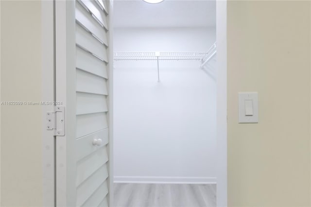 walk in closet featuring light hardwood / wood-style flooring