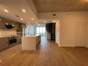 kitchen with stainless steel appliances and hardwood / wood-style floors