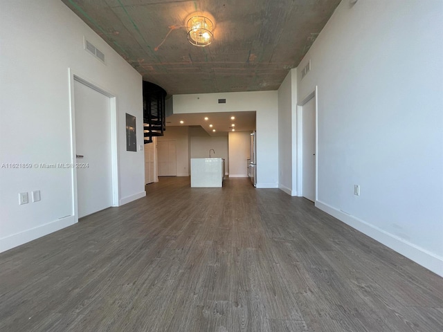 unfurnished living room with dark hardwood / wood-style flooring