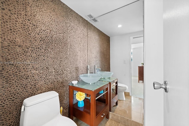 bathroom featuring vanity, tile patterned flooring, and toilet