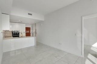 unfurnished living room with light tile patterned floors