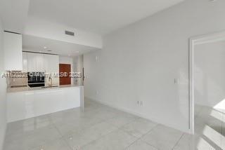 2678 Tigertail Ave Unit 515, Miami, FL 33133 - unfurnished living room featuring light tile patterned floors