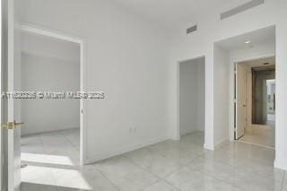 2678 Tigertail Ave Unit 515, Miami, FL 33133 - unfurnished bedroom with visible vents and tile patterned flooring