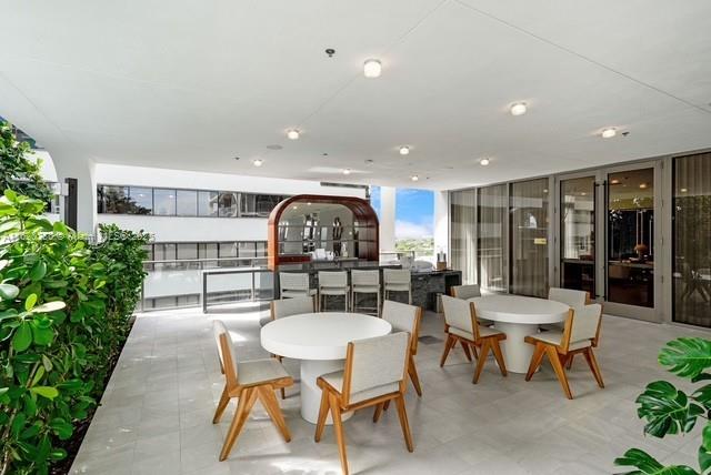 dining space with a wall of windows