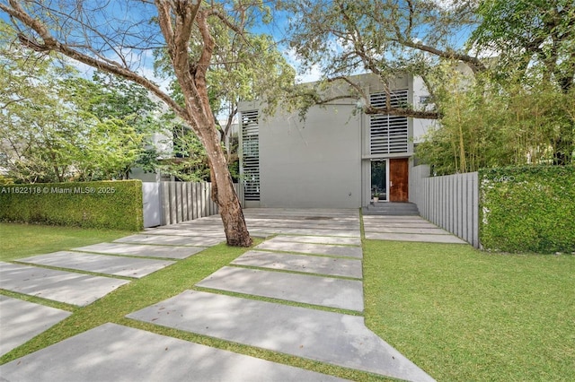 back of property featuring a fenced in pool, a yard, and a patio area