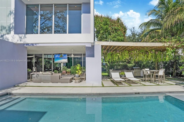 view of pool with an outdoor living space and a patio area