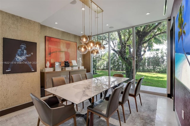 dining space with expansive windows and a notable chandelier