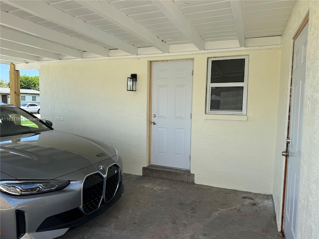 property entrance featuring a carport