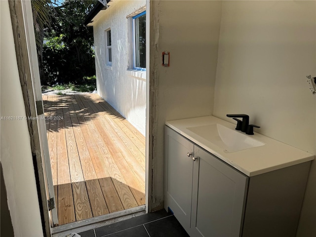 exterior space featuring tile patterned flooring and vanity