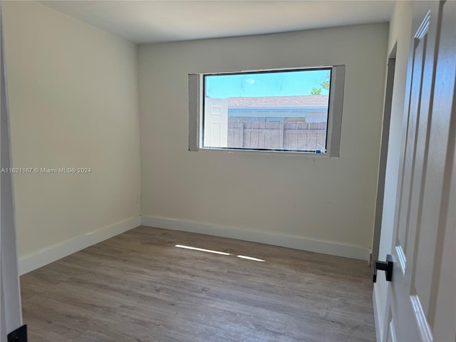 unfurnished room featuring hardwood / wood-style flooring