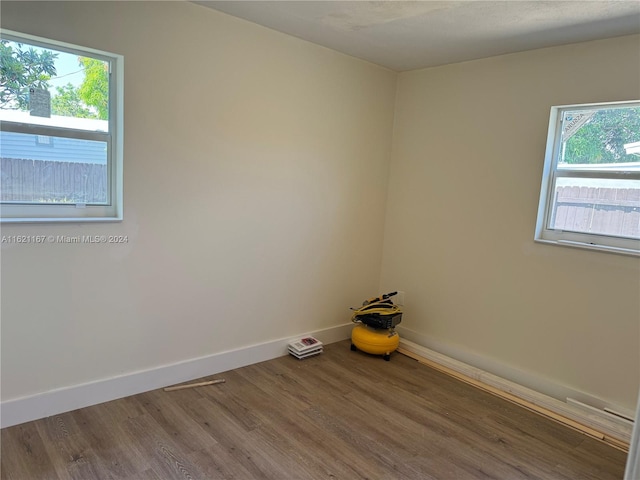 unfurnished room featuring hardwood / wood-style floors and a wealth of natural light