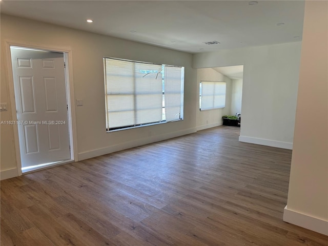 spare room featuring wood-type flooring