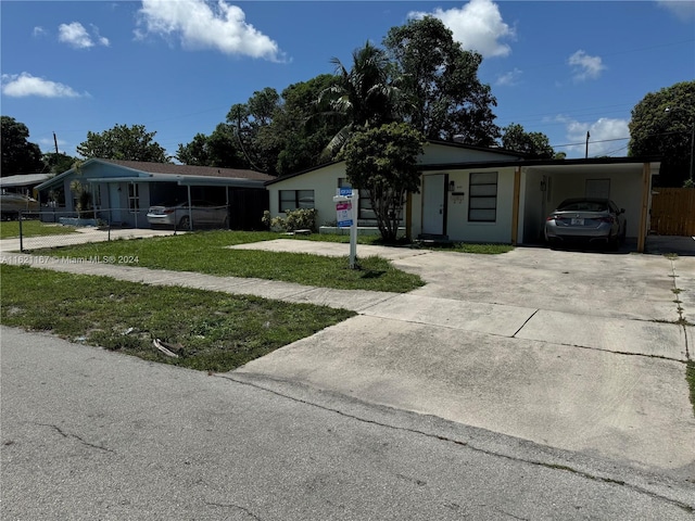 view of front facade with a carport and a front lawn