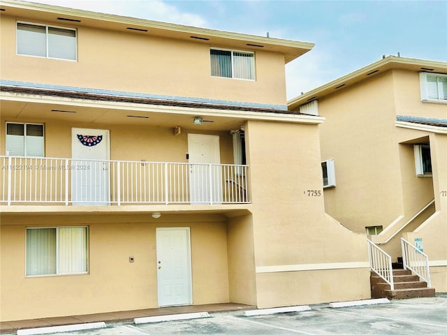 rear view of property featuring a balcony