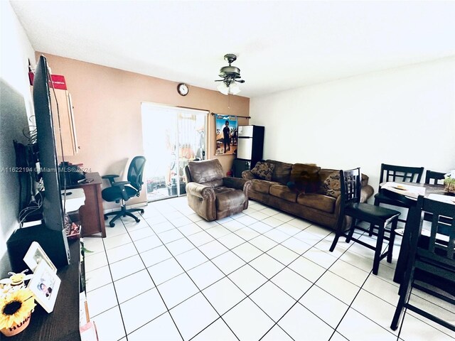 tiled living room featuring ceiling fan