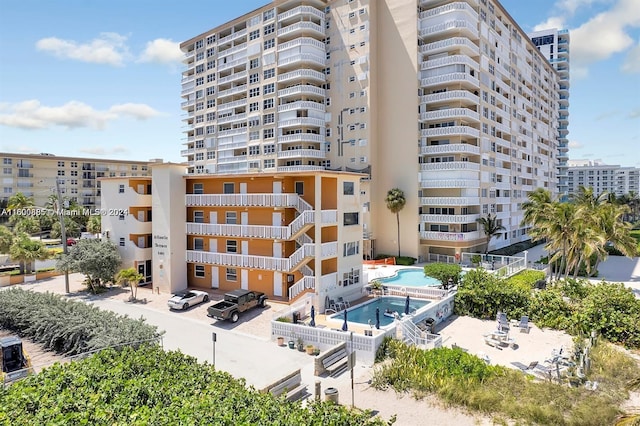 view of building exterior with a community pool