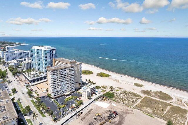 bird's eye view with a water view and a beach view