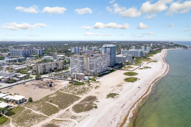 aerial view with a water view and a beach view