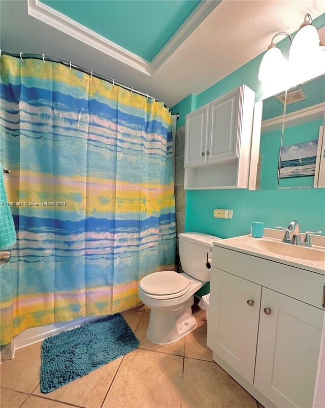 bathroom with vanity, tile patterned floors, crown molding, and toilet