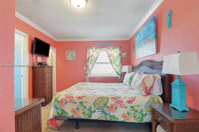 tiled bedroom with a textured ceiling and ornamental molding