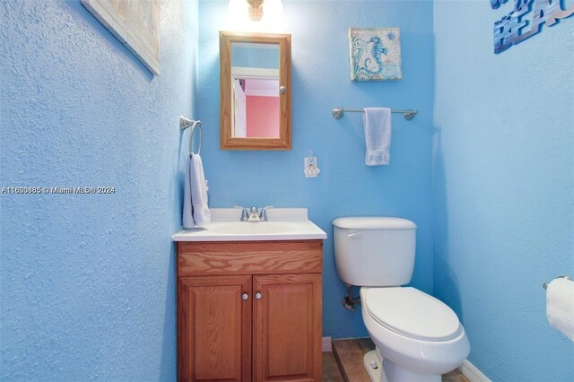 bathroom featuring tile patterned floors, toilet, and vanity