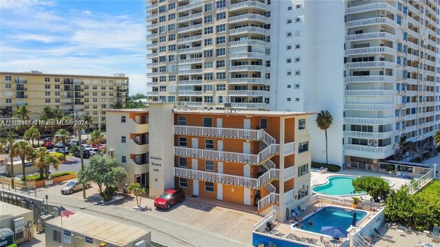 view of building exterior featuring a community pool