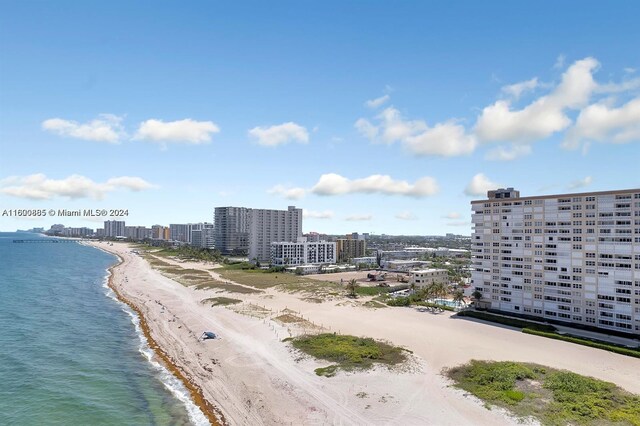 drone / aerial view featuring a water view and a beach view