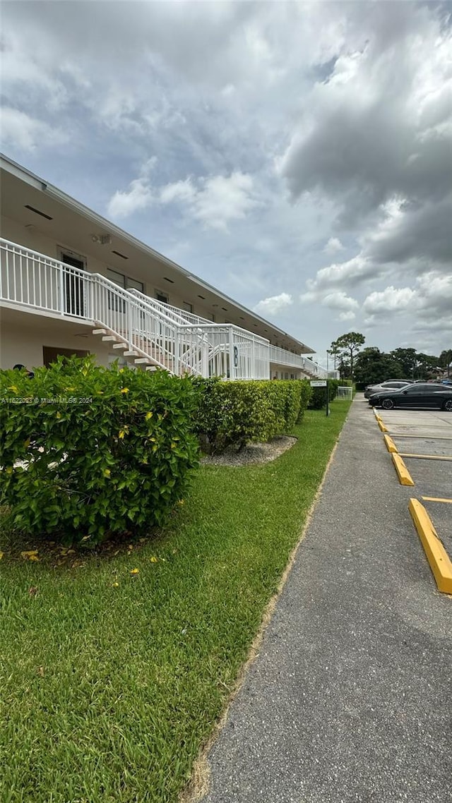 view of property exterior with a lawn