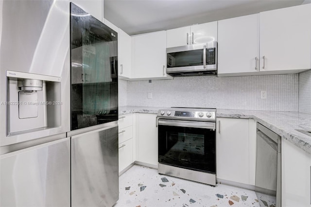 kitchen with white cabinetry, light stone countertops, appliances with stainless steel finishes, and decorative backsplash