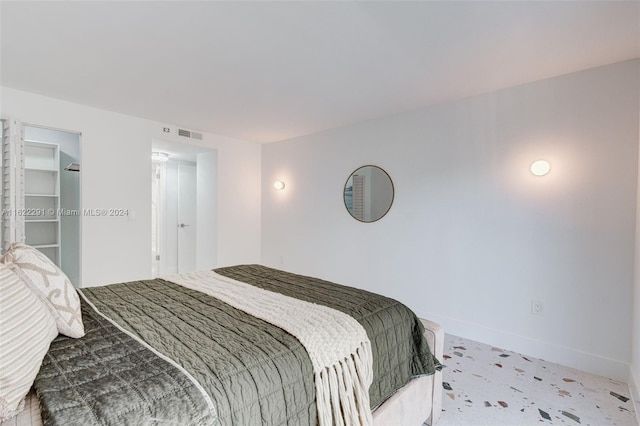 carpeted bedroom featuring a closet and a spacious closet