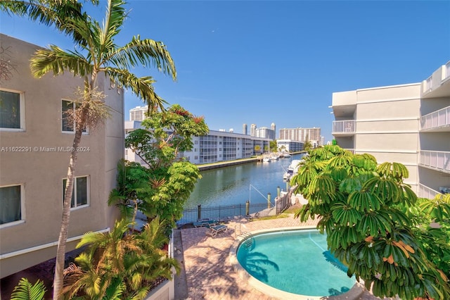 view of pool featuring a water view