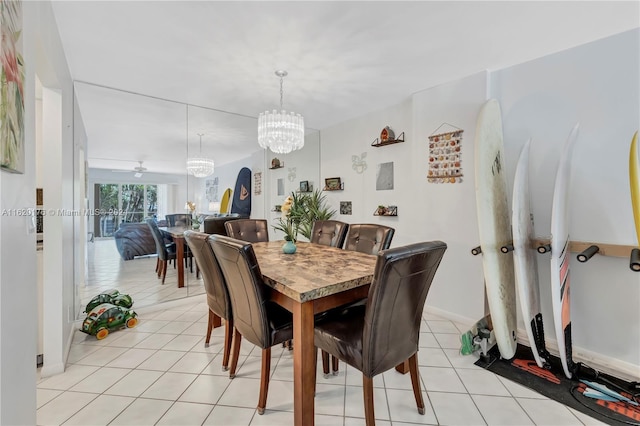 dining area featuring light tile patterned flooring and ceiling fan with notable chandelier