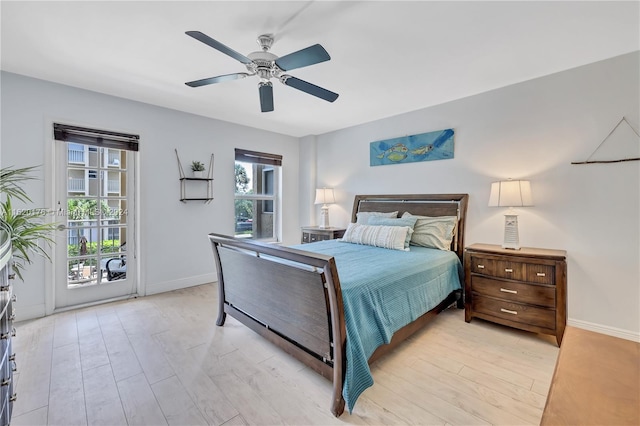 bedroom featuring ceiling fan, multiple windows, and light wood-type flooring