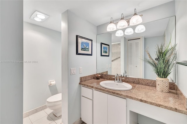 bathroom featuring vanity, tile patterned flooring, and toilet