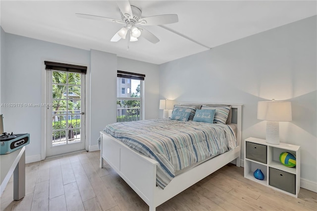 bedroom with ceiling fan, access to exterior, and light hardwood / wood-style flooring