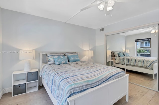 bedroom with ceiling fan, a closet, and light hardwood / wood-style flooring