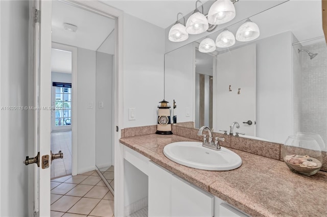 bathroom with tile patterned floors, vanity, and a shower