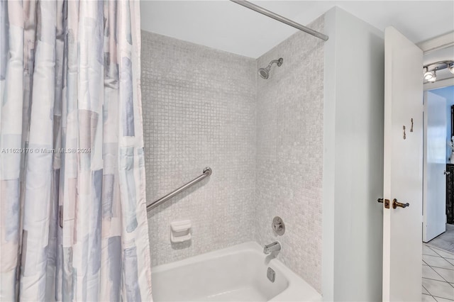 bathroom featuring shower / tub combo with curtain and tile patterned floors